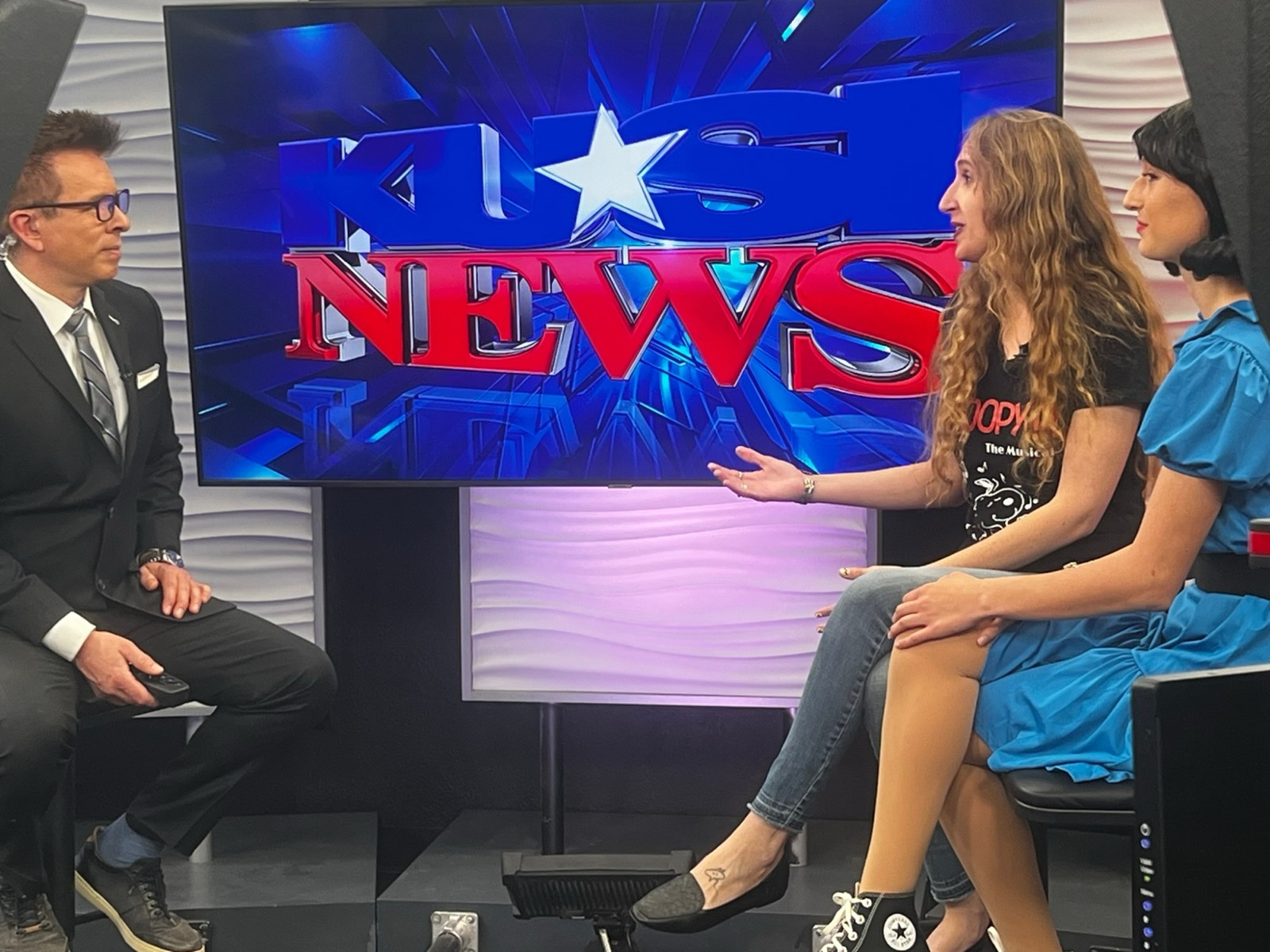 Taylor Fox interviewed on the KUSI News set beside a student in costume