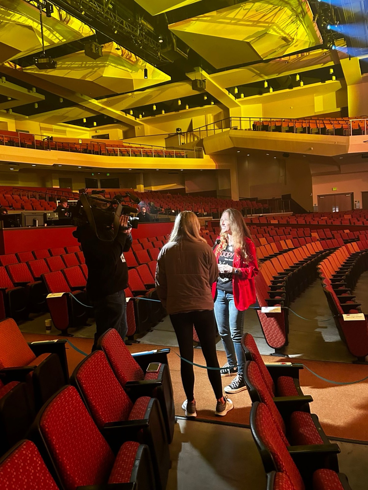 Taylor Fox giving an on-camera interview inside the theater before a performance