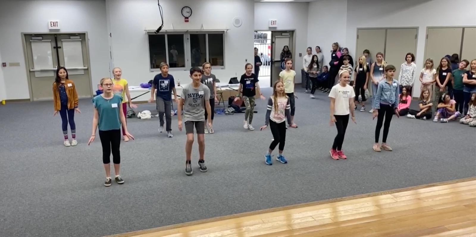 Young performers auditioning in a rehearsal hall