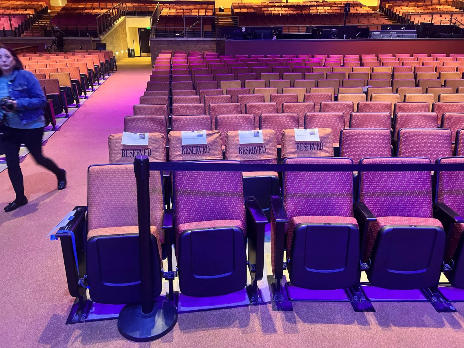Rows of reserved seats in an empty auditorium before a show