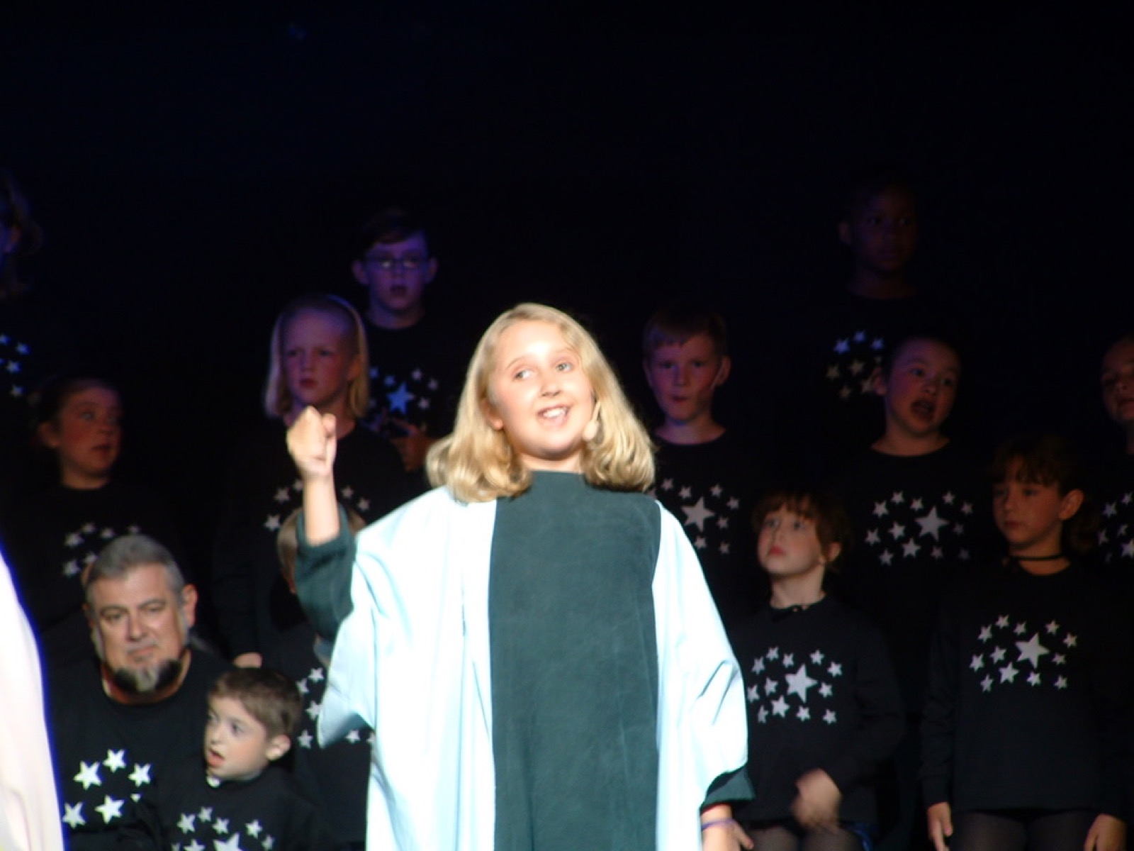 A young Taylor Fox singing a solo in front of a children's choir